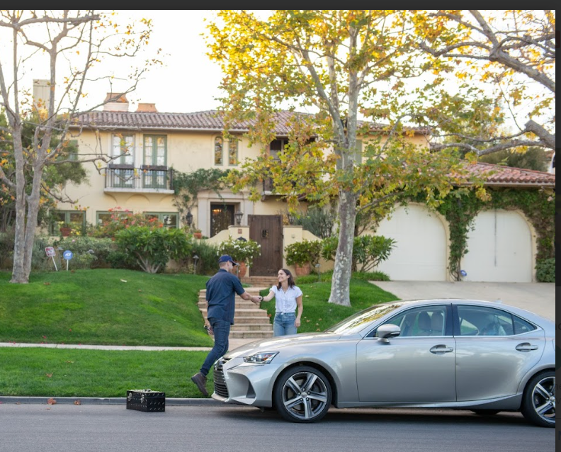 Mobile mechanic servicing a vehicle at a customer's home